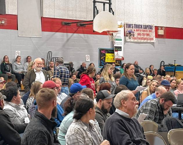 Special education took center stage at Epsom's school budget deliberative session on Tuesday, Feb. 4, 2025. Carol Zink-Mailloux (at microphone) led a motion to amend the petition warrant article capping the spending per pupil per year to $25,000. With the amendment, the cap now sits at $100,000. Representative Dan McGuire (last in line to speak) helped spearhead the effort for the petition warrant article.