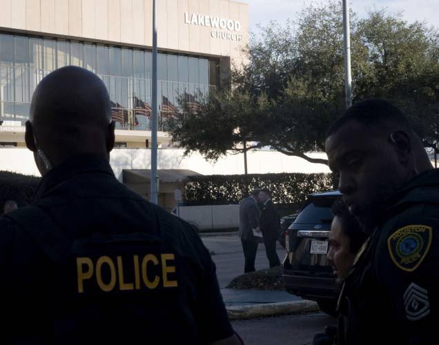 Police officers stand outside Lakewood Church during an active shooter situation at the church in Houston, Sunday, Feb. 11, 2024. (Kirk Sides/Houston Chronicle via AP)