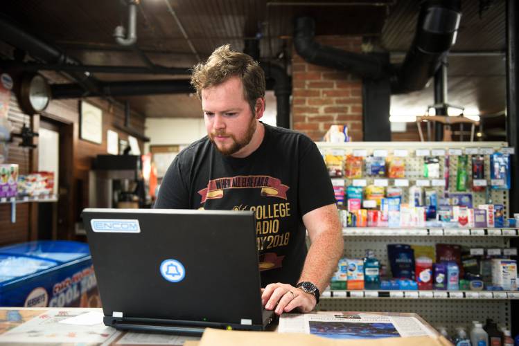 Patrick Schlott, of North Tunbridge, updates the software that translates an analog dialing pattern into a digital signal for his Randolph Telephone Operating Company phone at the North Tunbridge (Vt.) General Store, on July 5, 2024. Calls are routed through the store’s internet and Schlott himself pays a voice over internet protocol (VoIP) provider for the phone line and calls made. (Valley News - James M. Patterson) Copyright Valley News. May not be reprinted or used online without permission. Send requests to permission@vnews.com.
