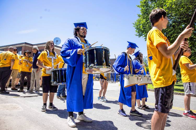 Franklin High School graduate Noah Azers-Azers, center, gets ready to lead the parade down Main Street on Thursday.