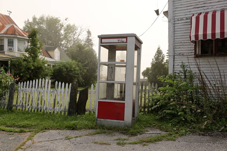 A disused public telephone booth remains outside of Floyd’s General Store in Randolph Center.