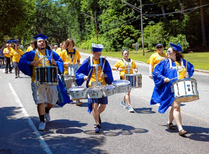 Franklin High School graduates Noah Azers-Azers (left), Virgilio Andrea, and Olivia Sylvester lead the parade down Main Street on Thursday, June 13, 2024.