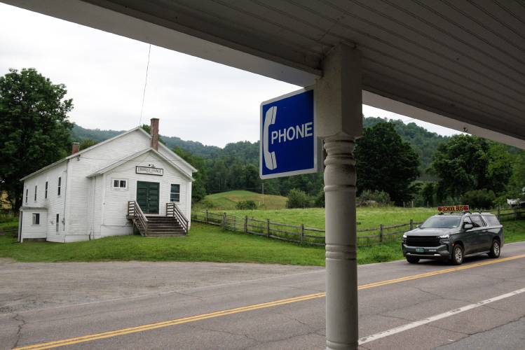 A sign notifies passers-by that a phone is available at the North Tunbridge (Vt.) General Store on Friday, July 5, 2024. Situated in a valley next to the First Branch of the White River, the village has little or no cellular phone signal. “What if your teenage kids were out there and the car broke down?” said store-owner Lois Gross. “It is a need,” to have a way to call for help. (Valley News - James M. Patterson) Copyright Valley News. May not be reprinted or used online without permission. Send requests to permission@vnews.com.