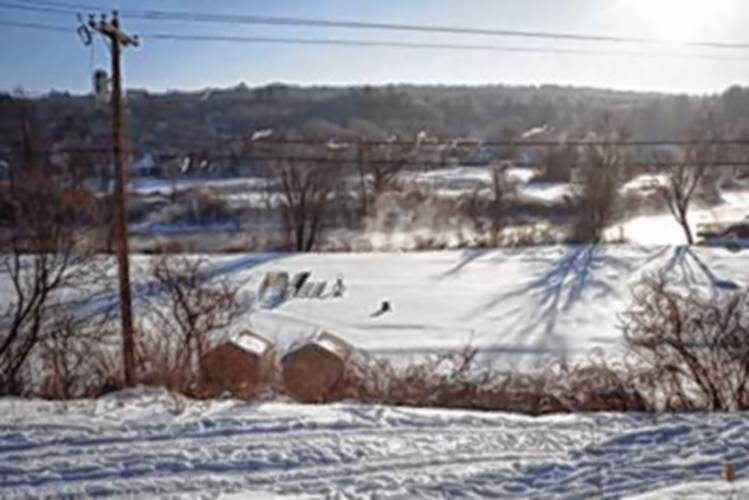 The lower field and track at Franklin High School is covered with snow on Wednesday morning. The school board approved a request for the field to be used for a community ice rink, and approval from the city council is pending.