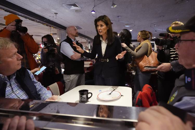 Republican presidential candidate and former UN Ambassador Nikki Haley, center, chats with guests during a campaign stop at Mary Ann's Diner on Jan. 19 in Amherst, N.H. 