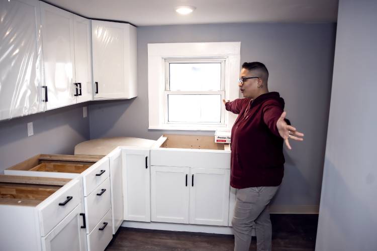 Glenda Leon, director of emergency housing at the Friends Program, shows the new kitchen on the second floor during a tour of the remodel of the Thompson Street facility for families on Wednesday. 