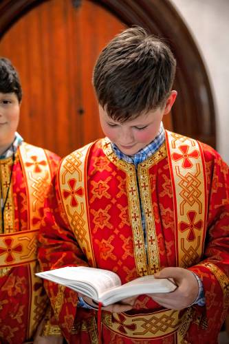 Altar boy Benjamin Vater gets ready for the Holy Trinity Greek Orthodox Chuchâs  Service of Lamentation marking the death of Christ on Holy Friday, May 3, 2024 to start the Easter weekend.