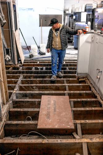 Dos Amigos owner Joel Harris shows the floor of the kitchen that needed to be replaced at the Main Street restaurant in downtown Concord on Tuesday. Harris hopes to re-open sometime next week.