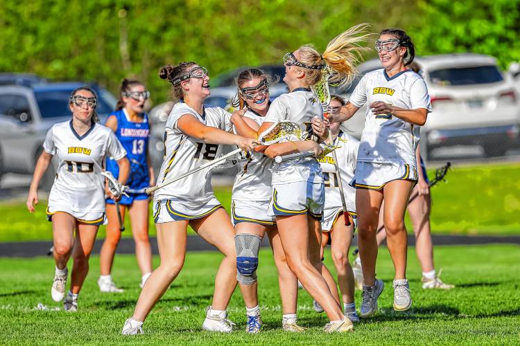 Olivia Selleck (8), Ella Gray (18) and Charlotte Duncan (5) surround Kendall Murray after Murray scored the game-winning goal in overtime against Londonderry on May 23.