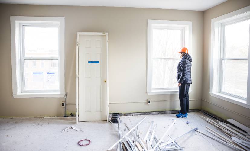 Maureen Beauregard, president and CEO of Easterseals NH & Vt, looks out from one of the new apartment being constructed at the former Webster Place in Franklin on Tuesday, April 8, 2025.