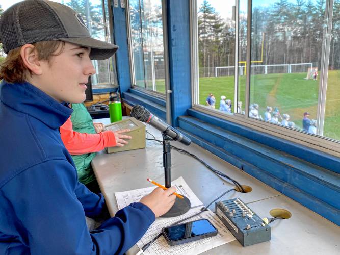 Merrimack Valley sophomore Nick Gelinas in the tower above the main athletic field at MVHS, where he announces the starting lineups before the game and the touchdowns and goal scorers during the action as the school athletic department’s public address announcer.