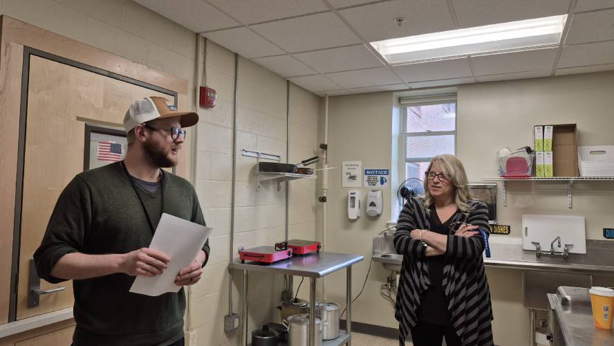 Sean Gravel and Michele Canning of NFI North discuss the meals being prepared in the kitchen at the adult transitional facility in Concord on Tuesday.