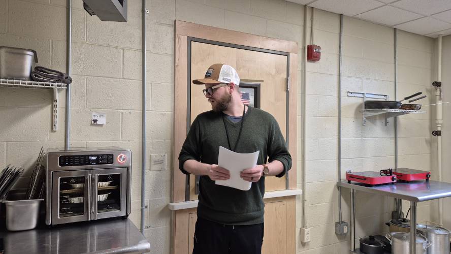 Sean Gravel, who works with NFI North, bakes a cake for one of the resident’s birthday at the adult transitional facility in Concord
