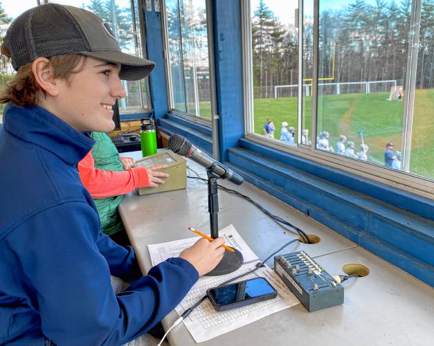 Merrimack Valley sophomore Nick Gelinas in the tower above the main athletic field where he announces the starting lineups before the game and the touchdown and goal scorers during the action as the public address announcer.