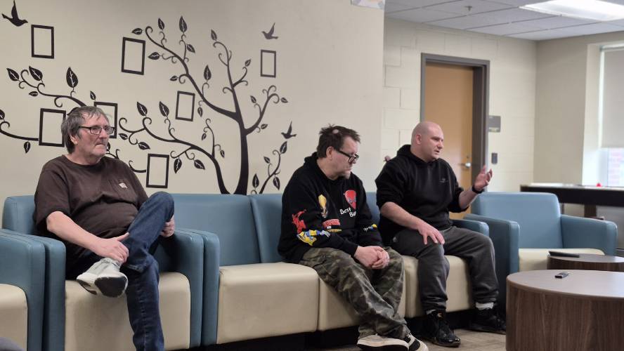 (From left) Tim Maley, Alfred Dion and Gage White at the Philbrook adult transitional housing facility’s common area on Tuesday.