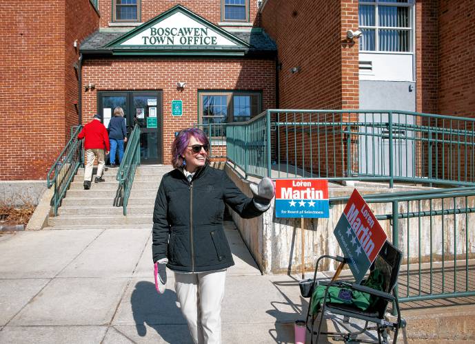 Candidate Loren Martin waves to passerbys outside the Boscawen Town Offices on Tuesday, March 11, 2025. Martin is running for the Board of Selectmen seat currently held by Lorrie Carrie.